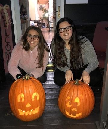 girls displaying their pumpkins